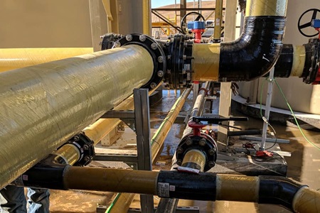 TS&M Supply's Fiberglass facility showcasing an array of fittings and extensive fiberglass piping, highlighting their specialized infrastructure.