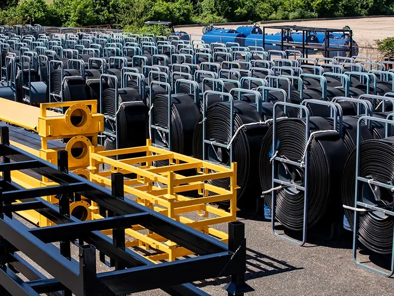 Trojan - multiple reels of layflat hose and fabricated equipment are staged in our yard
